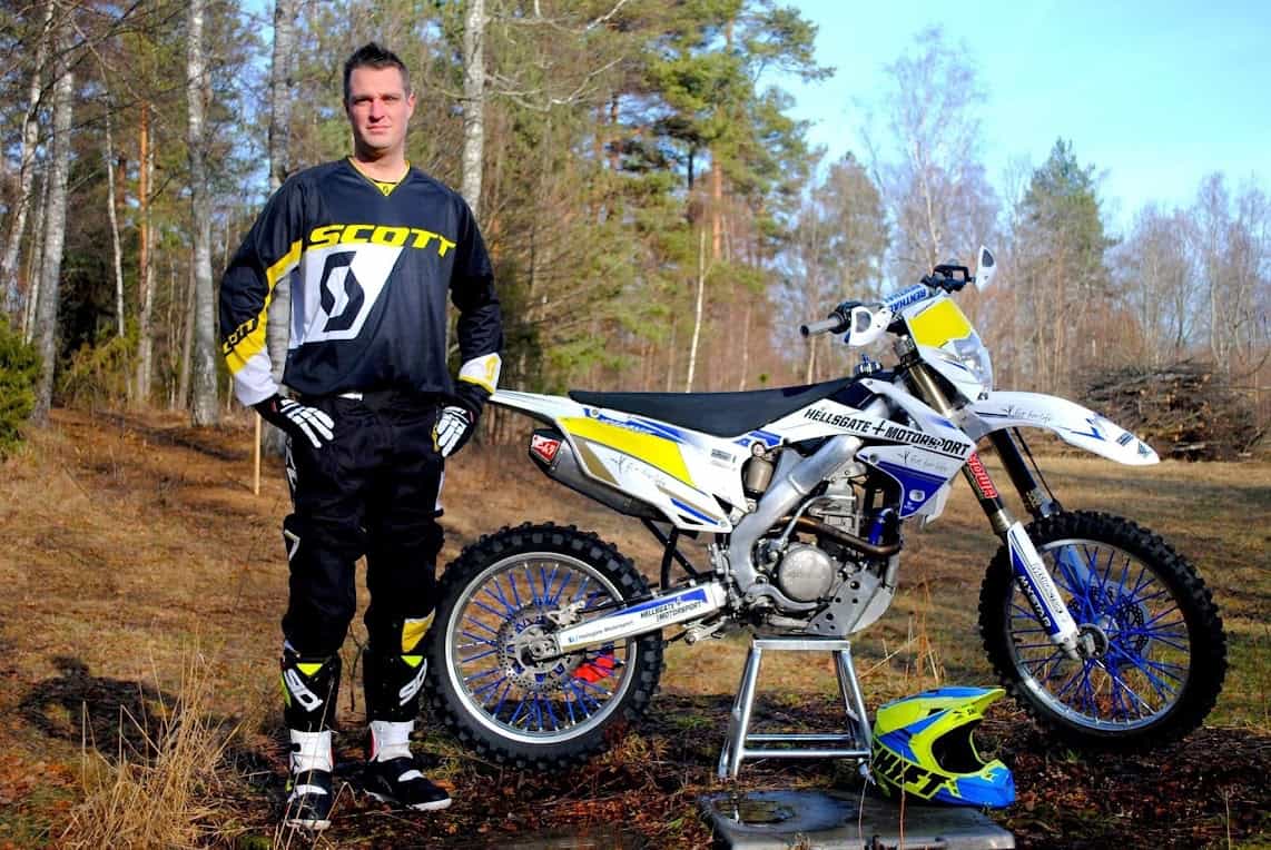 Adam Wiegandt standing next to a dirt bike