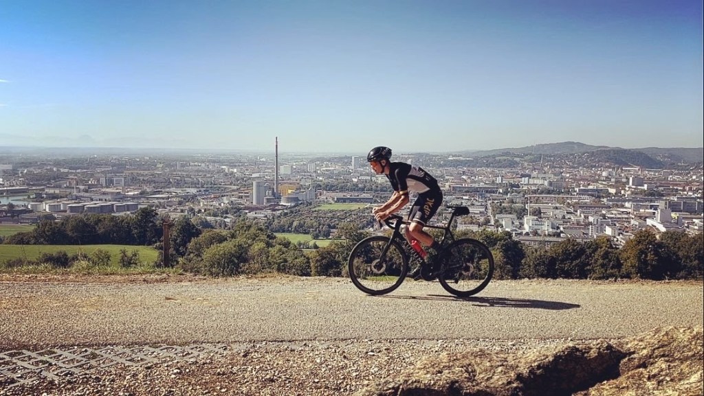 Elite Cyclist Daniel Pettinger riding bike outdoors on a hill