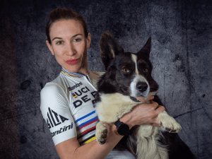 Elite Cyclist Laura Šimenc holding her dog