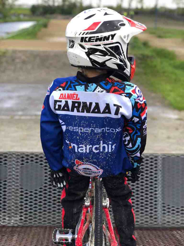 Boy riding BMX bike with name Garnaat on back