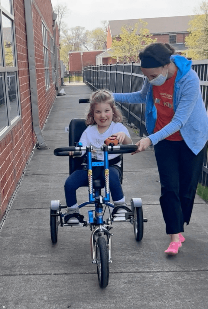 Lucy Kipping-Ruane riding an adaptive bike