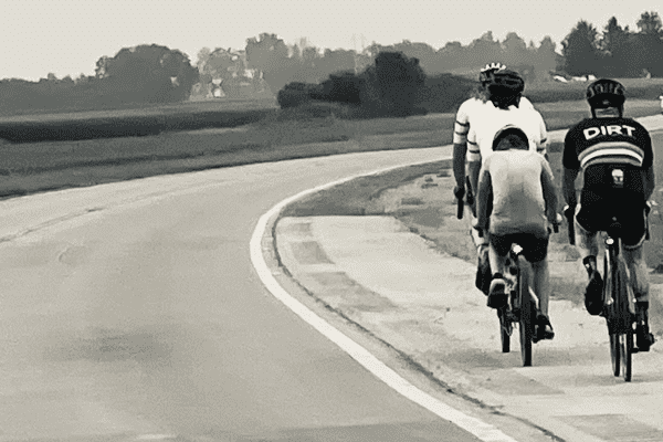 Masters Athlete Endurance Training cyclist riding down a road