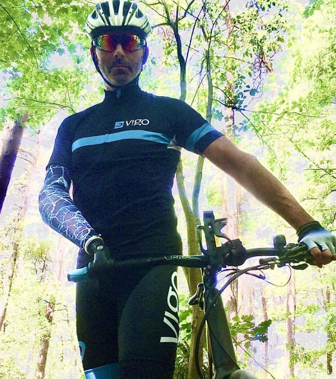 One-Armed Cyclist Jan Butaye standing proudly with prosthetic arm