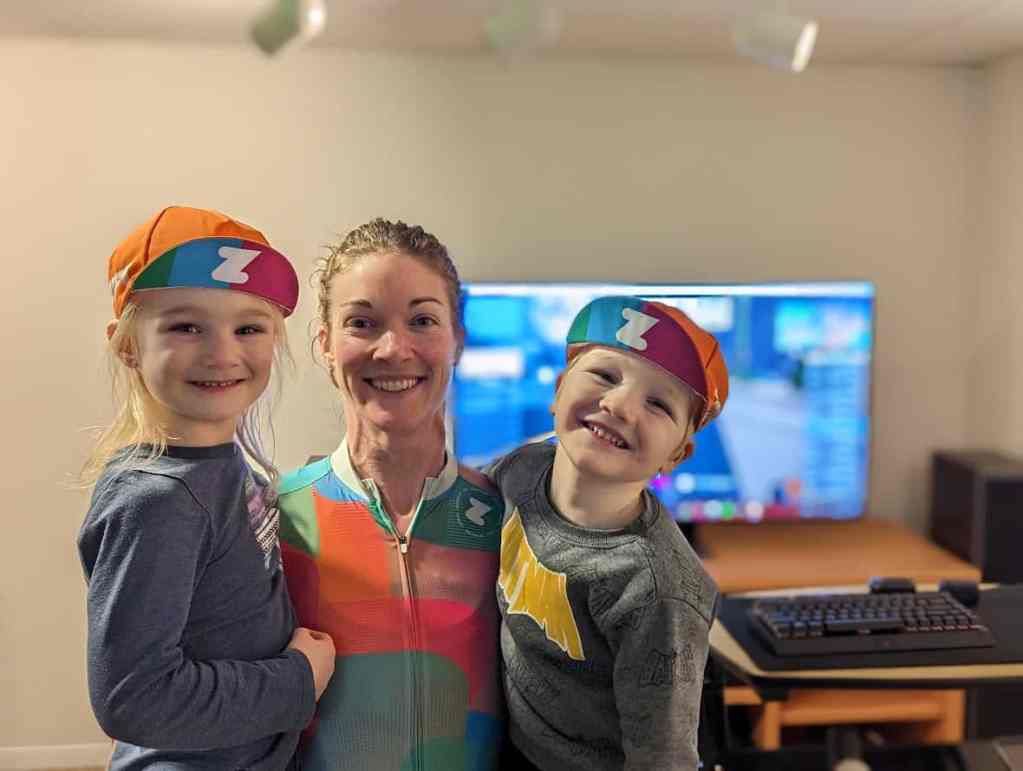 Elite esports cyclist Liz Van Houweling holding her two young children