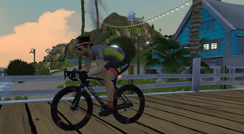 Zwift avatar riding on a wooden bridge