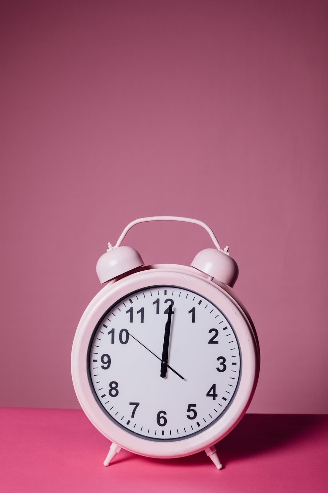 Pink old fashioned wind up clock